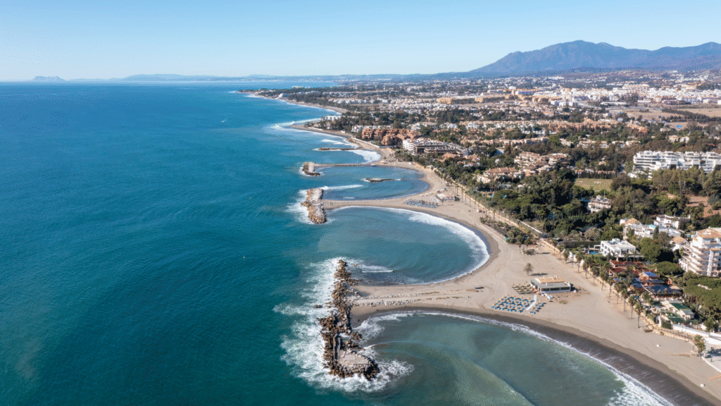 Aerial view of the Marbella coastline and Nueva Andalucía beaches—top residential area for expats on the Costa del Sol—Quintessentia Property Advisors