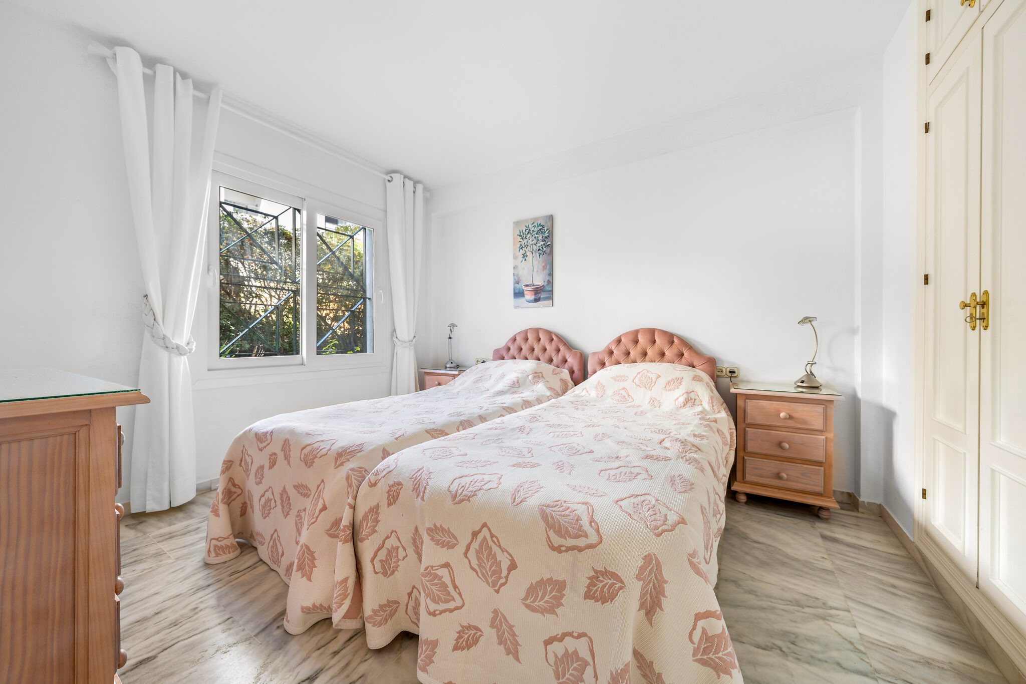 Guest bedroom with large window in Estepona beachfront property