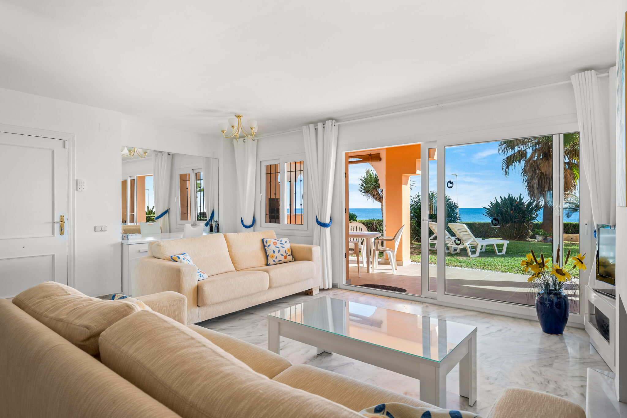 Bright living room with garden access in beachfront apartment Estepona