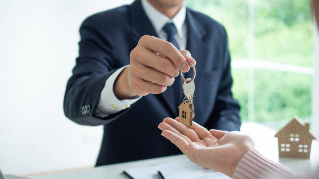 Real estate agent handing over house keys during a property purchase in Estepona.