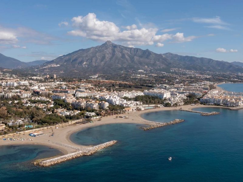 Aerial view of Nueva Andalucia and Marbella coastline, Spain, showing luxury homes and Mediterranean beaches, highlighting the differences in lifestyle and property appeal in Nueva Andalucia vs Marbella.