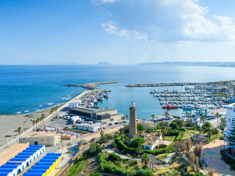 Aerial view of Estepona marina and beachfront apartments on the Costa del Sol, Spain, showcasing prime real estate locations