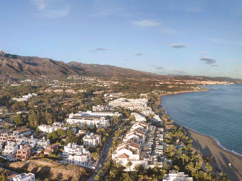 Aerial view of Nueva Andalucía and Marbella coastline with Mediterranean Sea and La Concha mountain in the background.